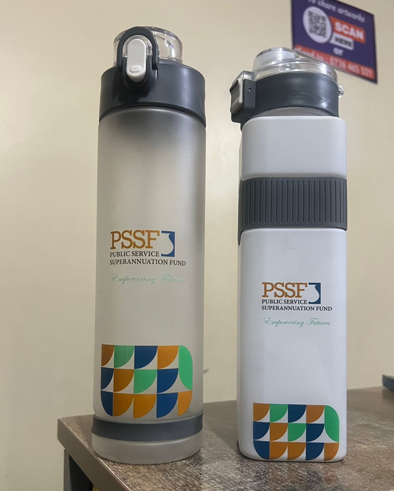 PSSF branded reusable water bottles displayed on a table